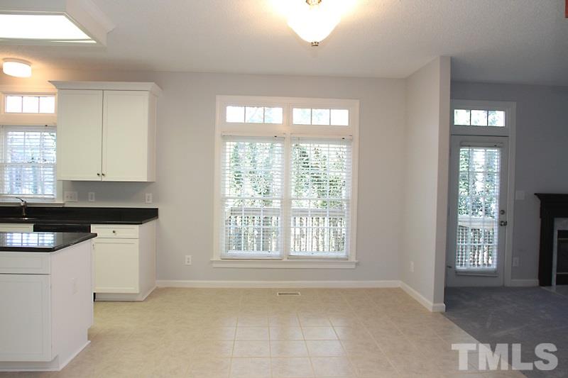 9021 Breeland Way Raleigh, NC 27613 - Photo 8 of 20 a kitchen with a stove a sink and a window