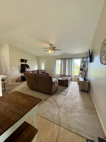 a living room with furniture window and a table