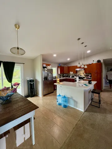 a kitchen with a sink a counter top stainless steel appliances and cabinets