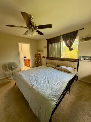 a bed sitting in a bedroom next to a window