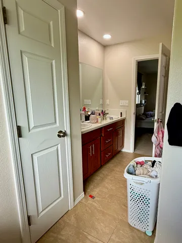 a bathroom with a sink double vanity and mirror