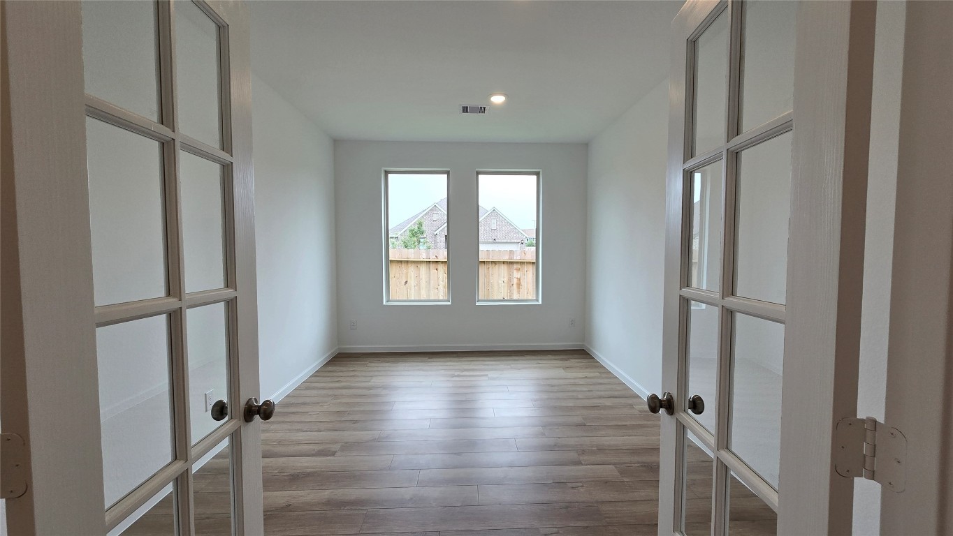 8223 Holly Blue Drive Rosharon, TX 77583 - Photo 30 of 48 a view of a hallway with wooden floor and staircase