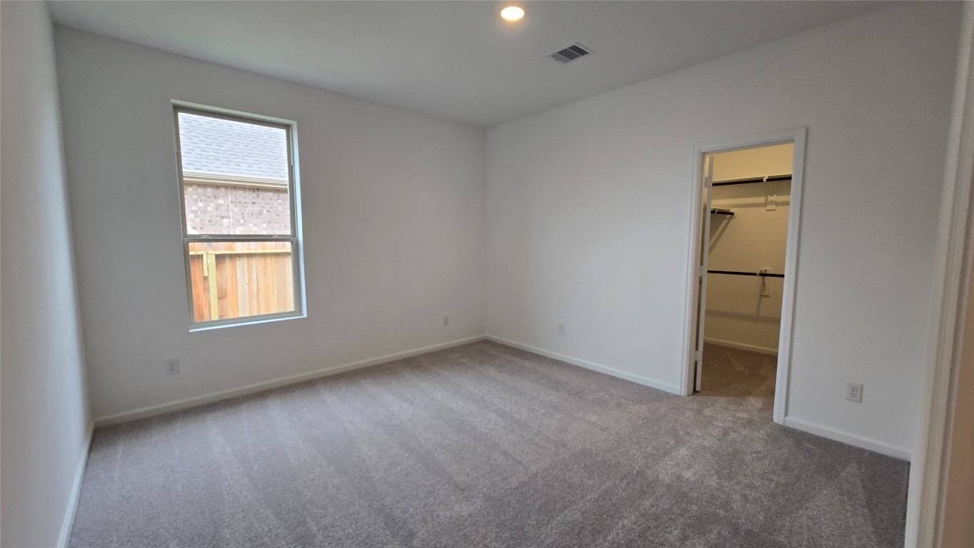 8223 Holly Blue Drive Rosharon, TX 77583 - Photo 37 of 48 an empty room with a window and wooden floor