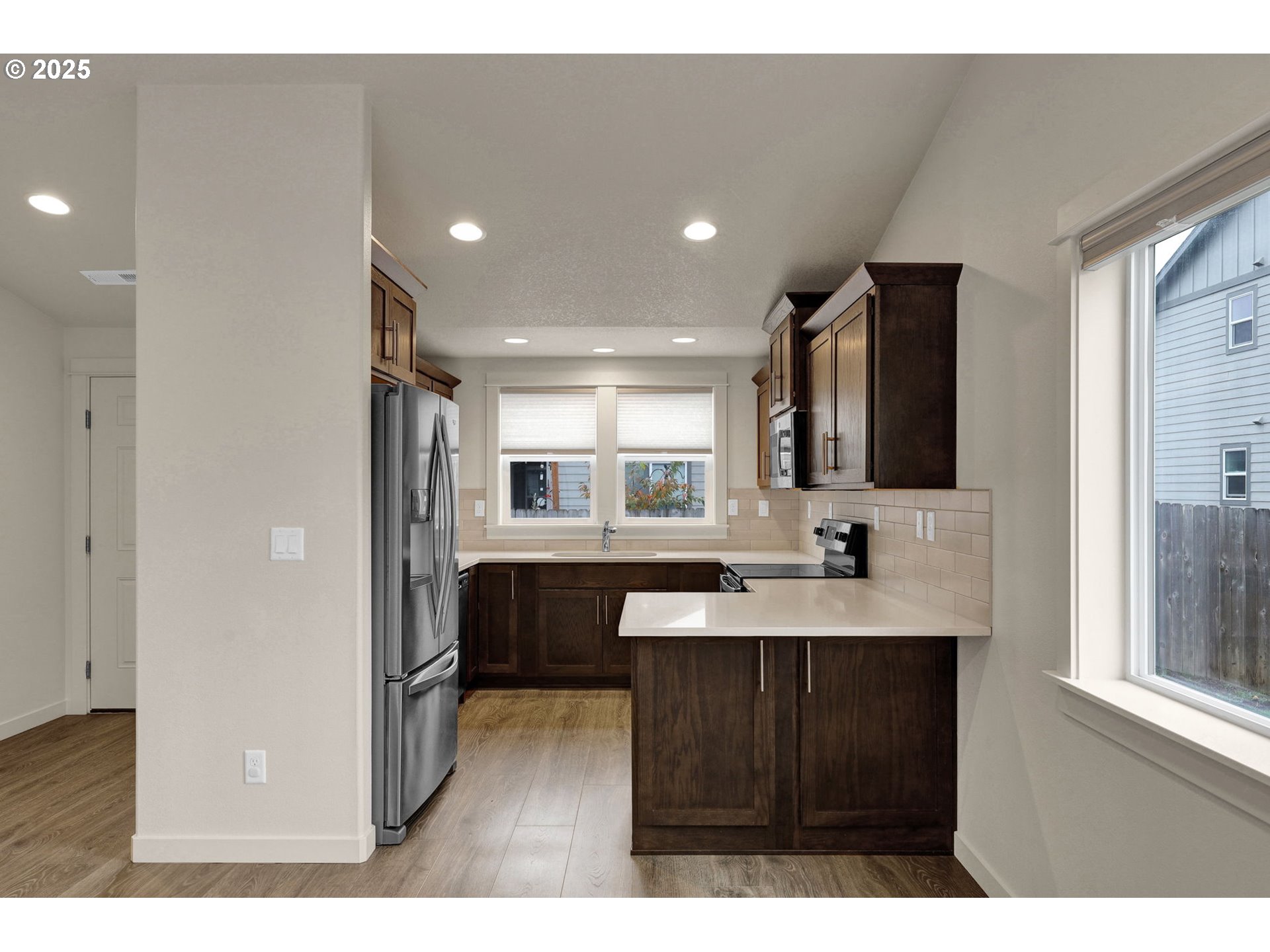 1632 Dotie Drive Springfield, OR 97477 - Photo 8 of 29 a kitchen with kitchen island a sink stainless steel appliances and cabinets