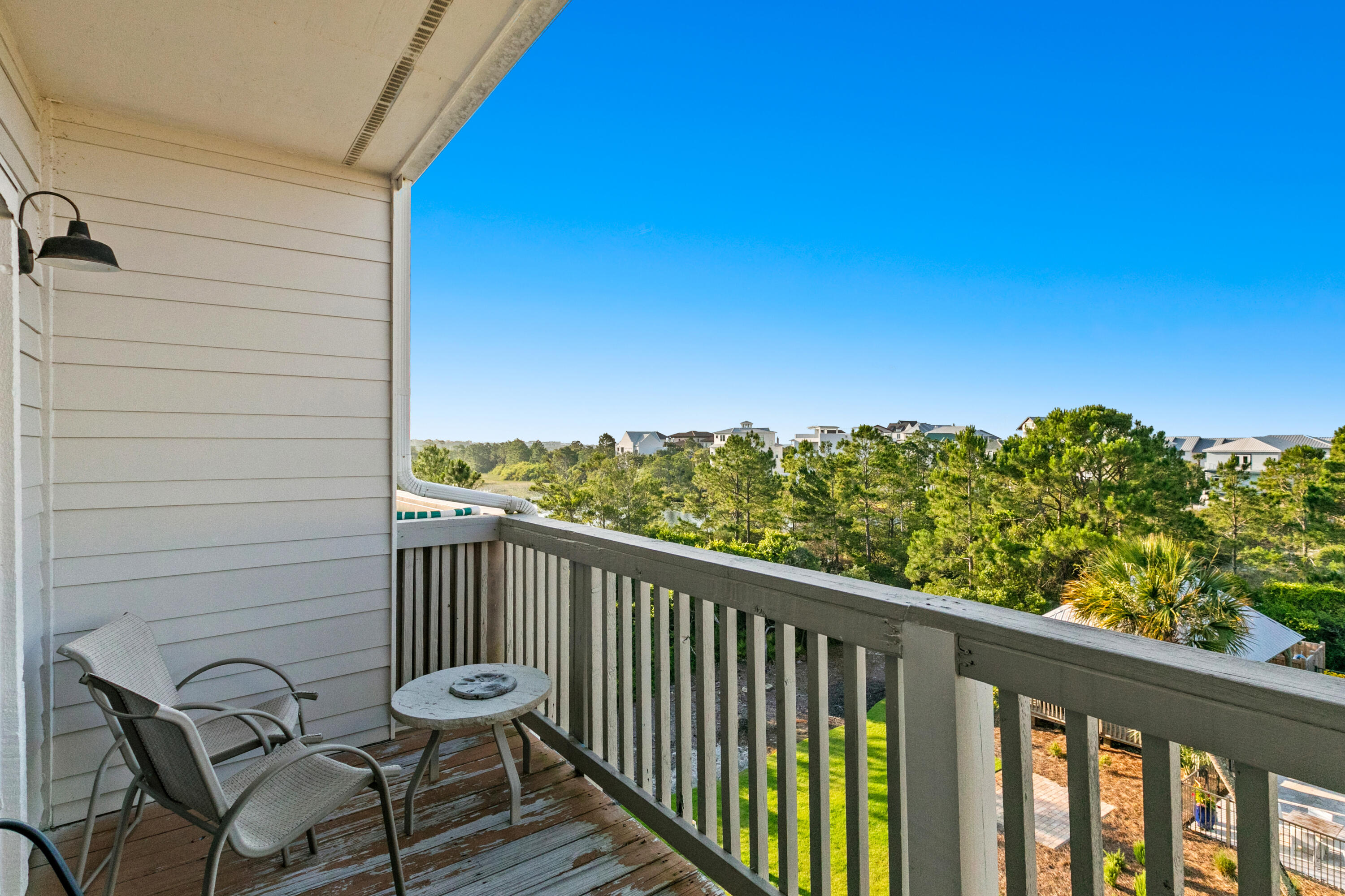 145 Beachfront Trail, Unit 302A Santa Rosa Beach, FL 32459 - Photo 19 of 21 a view of a balcony with chair and wooden fence
