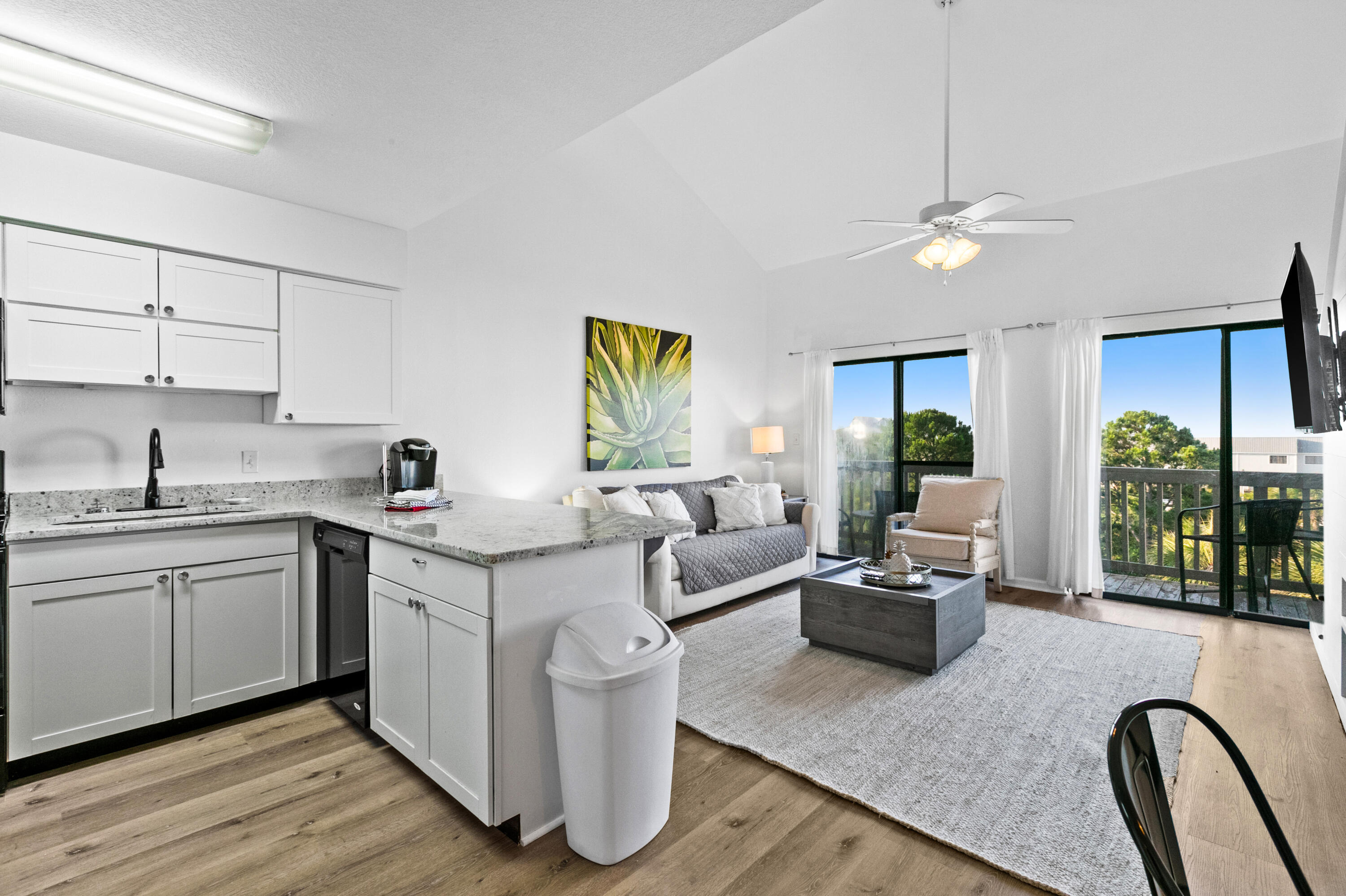 145 Beachfront Trail, Unit 302A Santa Rosa Beach, FL 32459 - Photo 2 of 21 a living room with furniture granite countertop kitchen view and a wooden floor