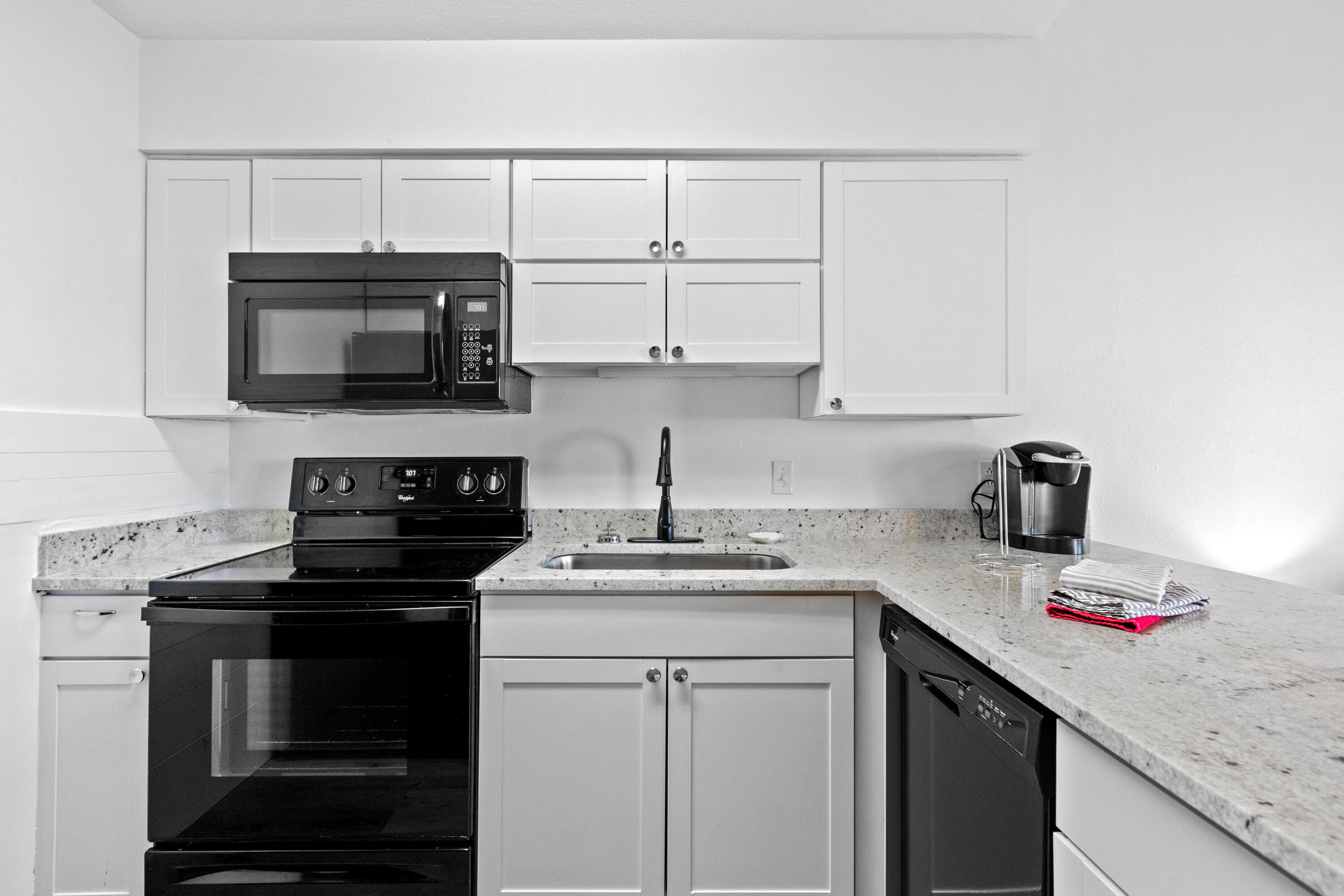 145 Beachfront Trail, Unit 302A Santa Rosa Beach, FL 32459 - Photo 3 of 21 a kitchen with stainless steel appliances granite countertop a sink stove and microwave