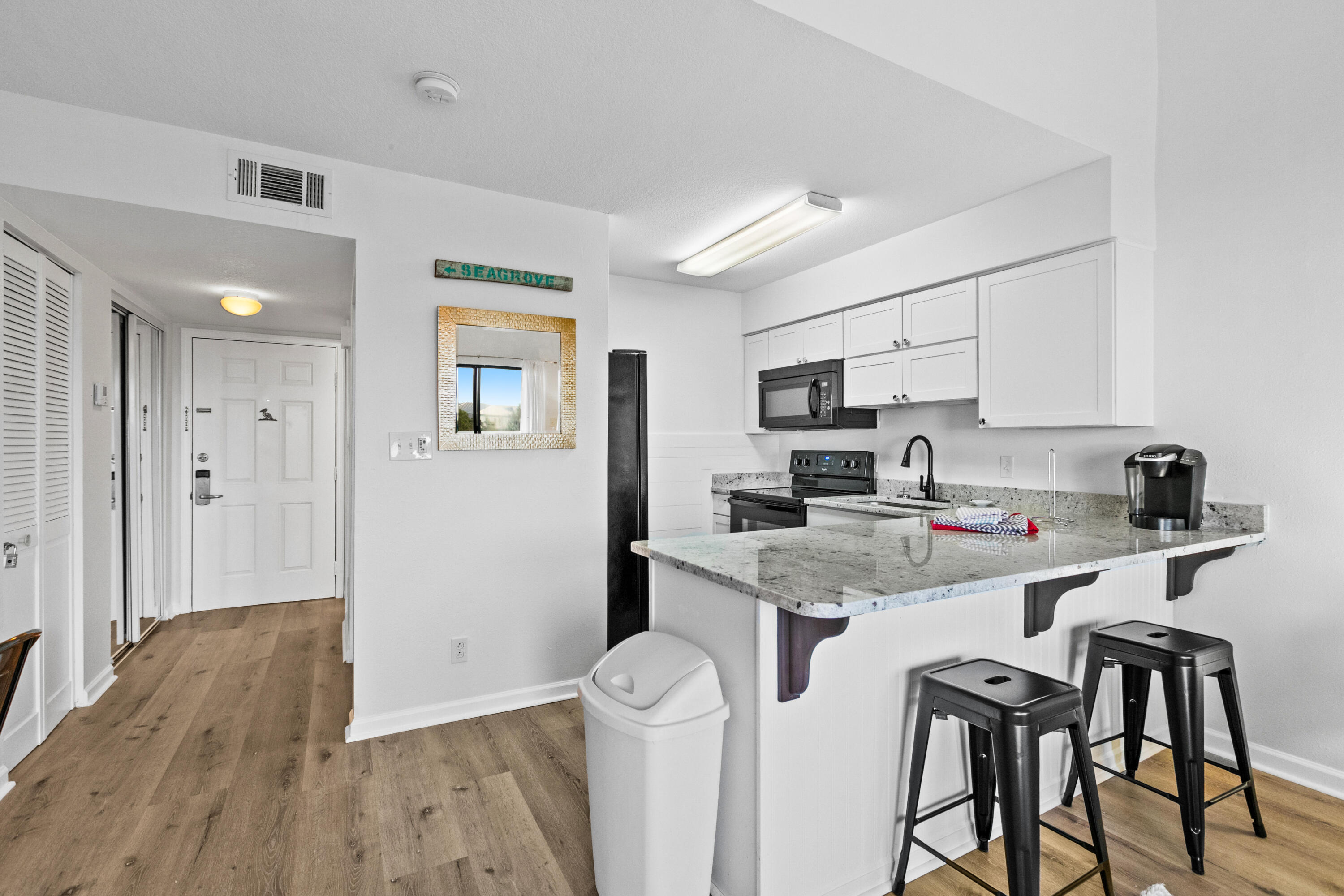 145 Beachfront Trail, Unit 302A Santa Rosa Beach, FL 32459 - Photo 4 of 21 a kitchen with stainless steel appliances granite countertop a sink and cabinets