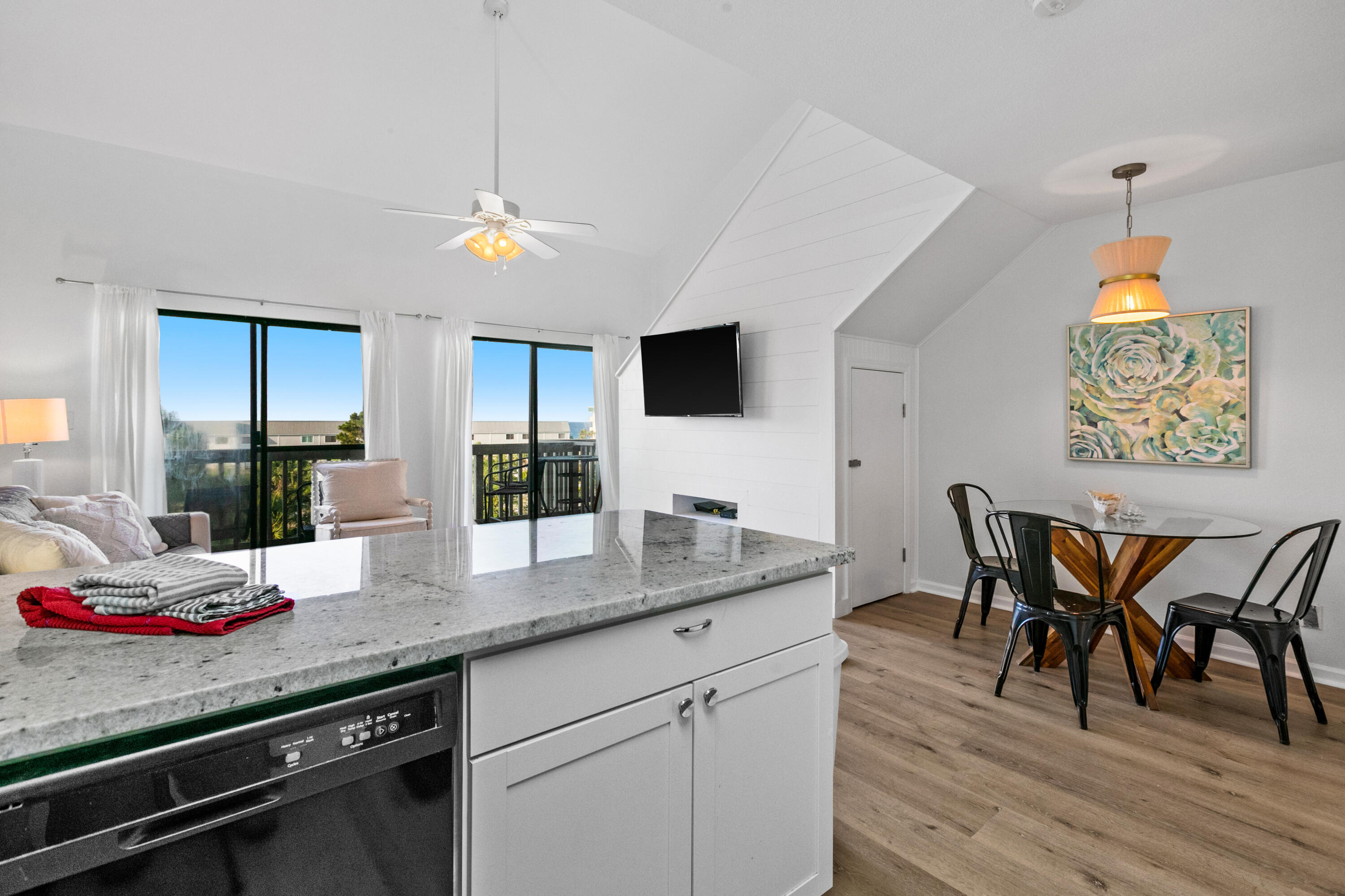 145 Beachfront Trail, Unit 302A Santa Rosa Beach, FL 32459 - Photo 5 of 21 a kitchen with stainless steel appliances granite countertop a dining table chairs and granite counter tops