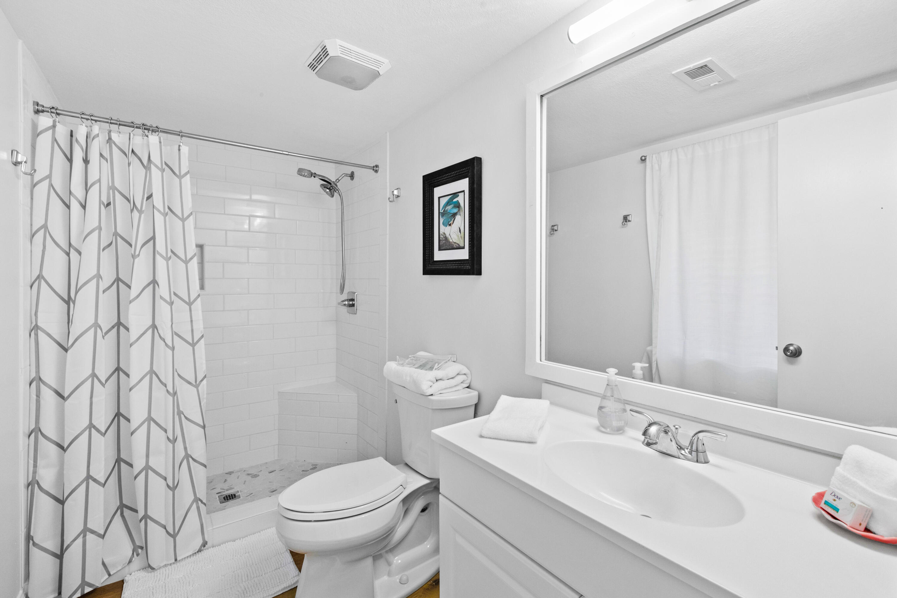 145 Beachfront Trail, Unit 302A Santa Rosa Beach, FL 32459 - Photo 9 of 21 a bathroom with a sink toilet and a mirror