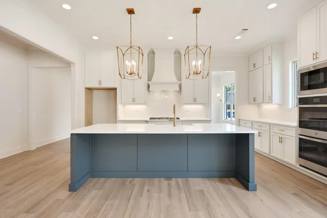 a very nice looking kitchen with granite countertop a stove and refrigerator