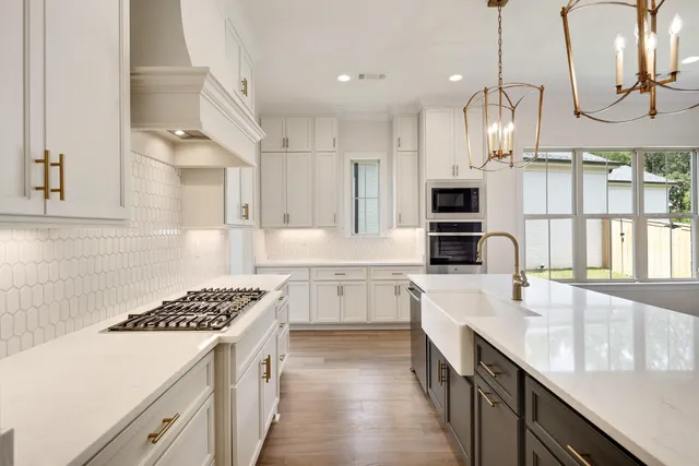 a kitchen with stainless steel appliances and cabinets