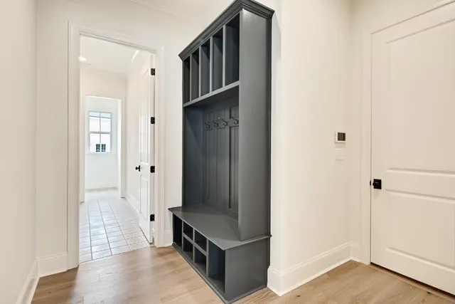 en empty room with wooden floor and ceiling fan