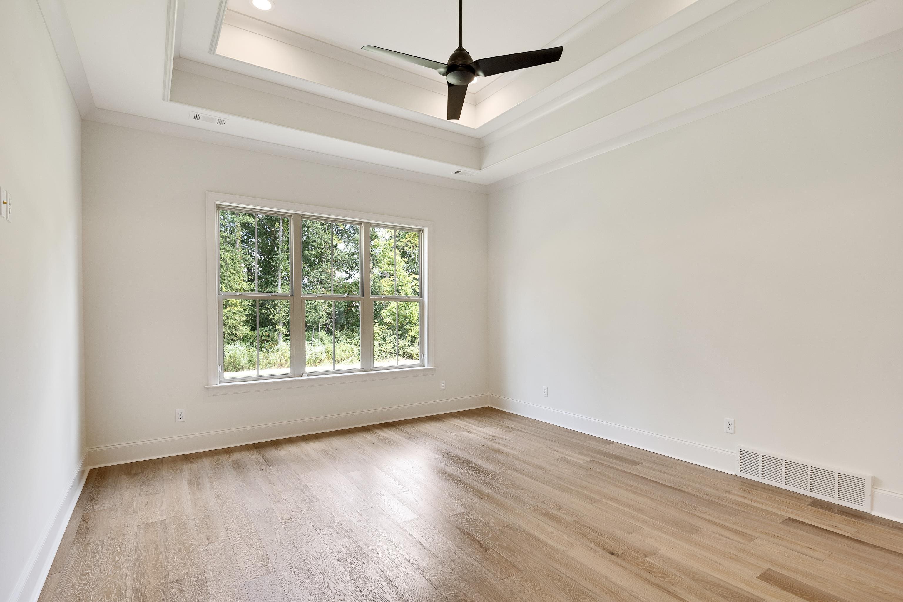 65 Magnolia Rdg Drive Rossville, TN 38066 - Photo 20 of 40 en empty room with wooden floor and ceiling fan