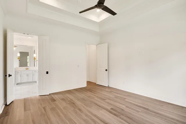 a spacious bathroom with a granite countertop sink a mirror a shower and a bathtub