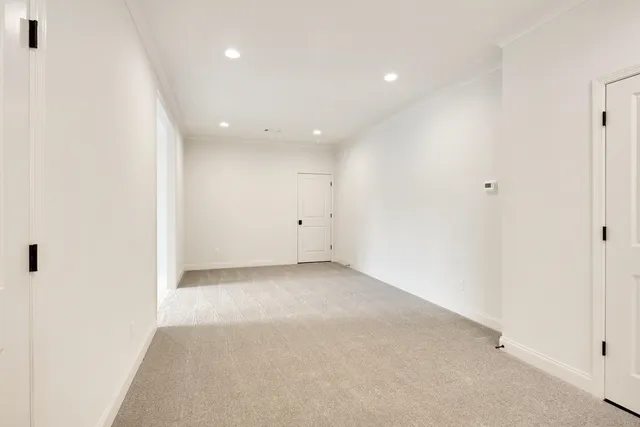 an empty room with a ceiling fan and a window