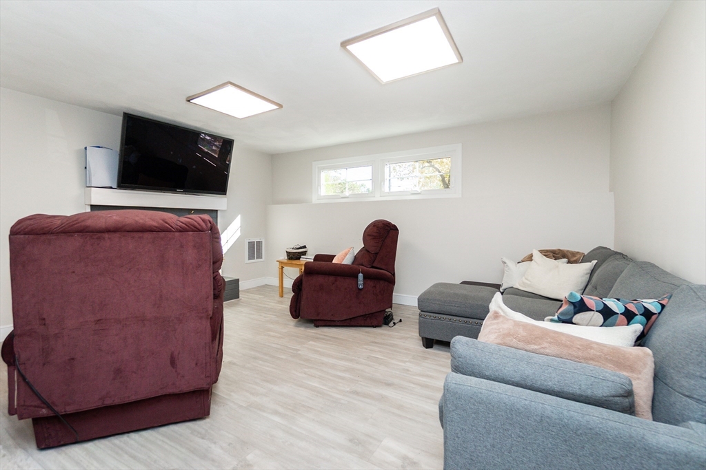 8 Sawyer Avenue Canton, MA 02021 - Photo 11 of 13 a living room with furniture and a flat screen tv
