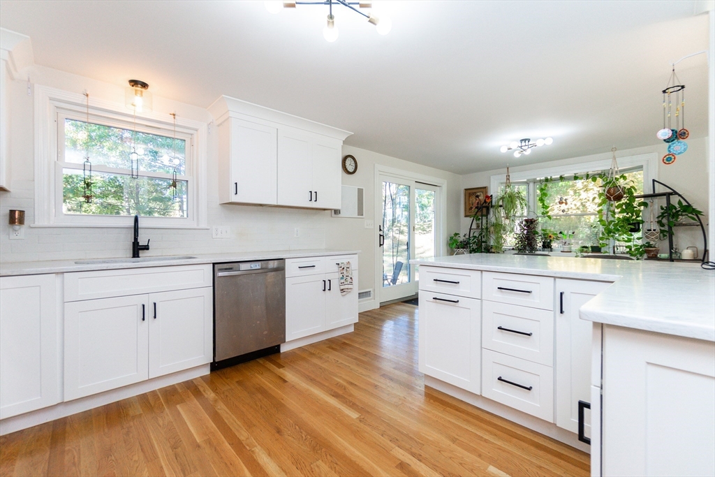 8 Sawyer Avenue Canton, MA 02021 - Photo 3 of 13 a kitchen with white cabinets and white appliances