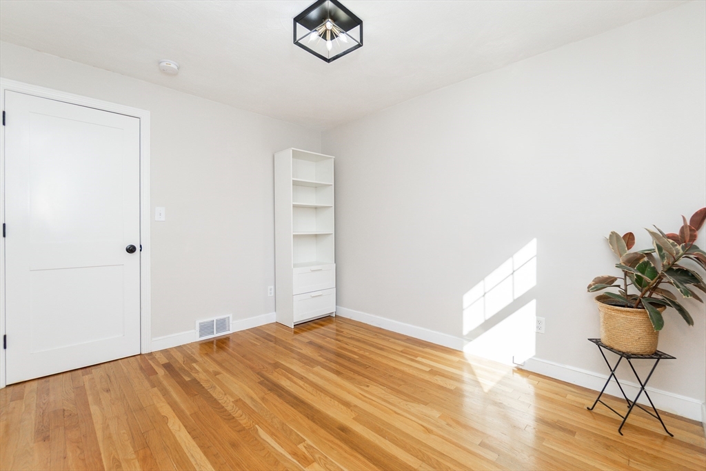 8 Sawyer Avenue Canton, MA 02021 - Photo 9 of 13 a bedroom with a bed and a potted plant