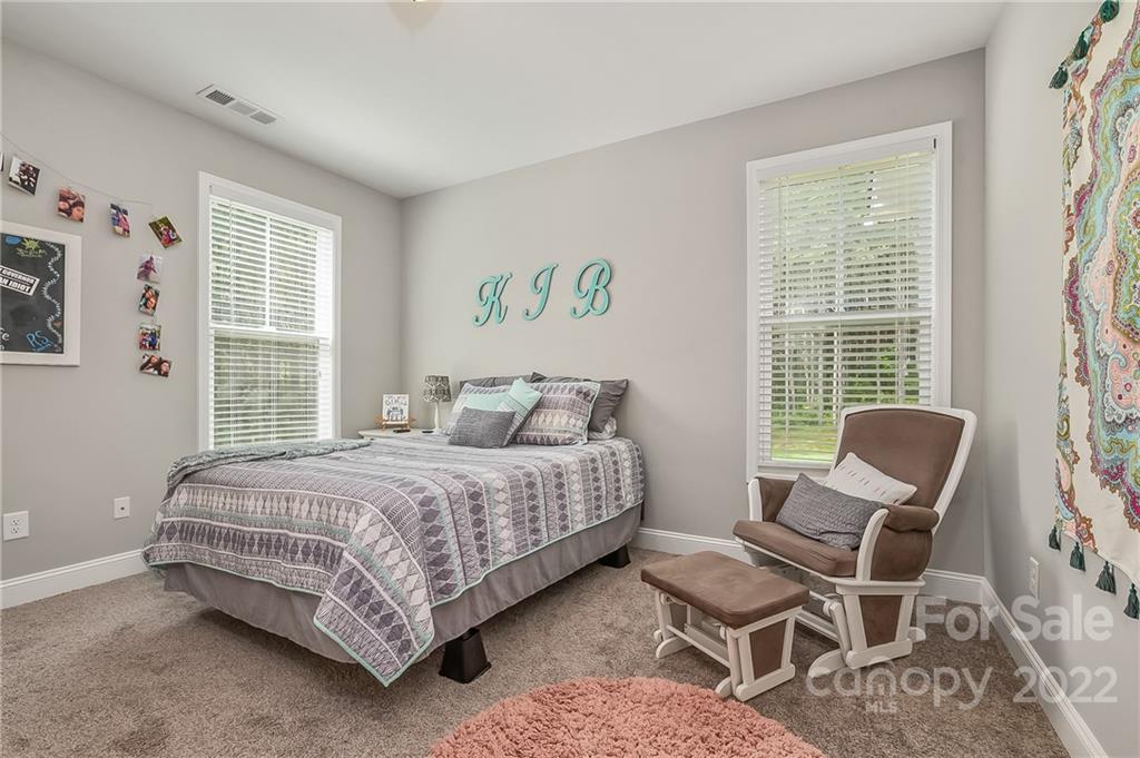 624 Spur Alley, Unit 19 Rutherfordton, NC 28139 - Photo 12 of 41 a bedroom with a bed and chair