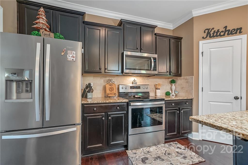 624 Spur Alley, Unit 19 Rutherfordton, NC 28139 - Photo 17 of 41 a kitchen with stainless steel appliances granite countertop a refrigerator stove and sink