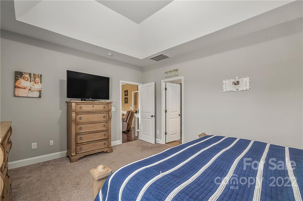 624 Spur Alley, Unit 19 Rutherfordton, NC 28139 - Photo 20 of 41 a bedroom with a bed and a flat screen tv