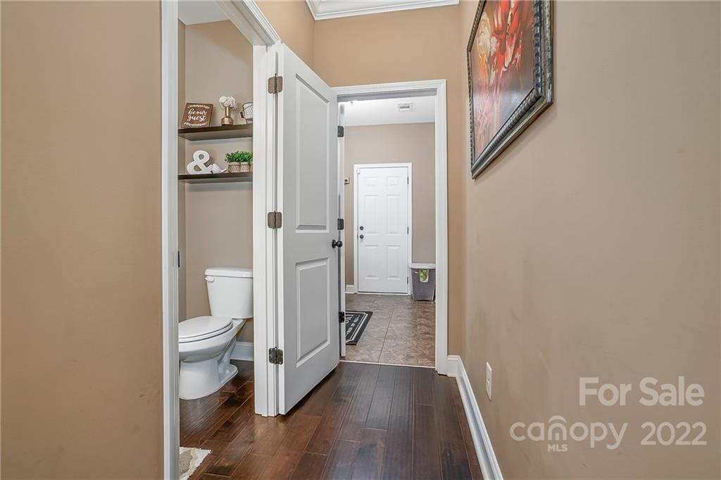 624 Spur Alley, Unit 19 Rutherfordton, NC 28139 - Photo 26 of 41 a view of a hallway with wooden floor and a bathroom