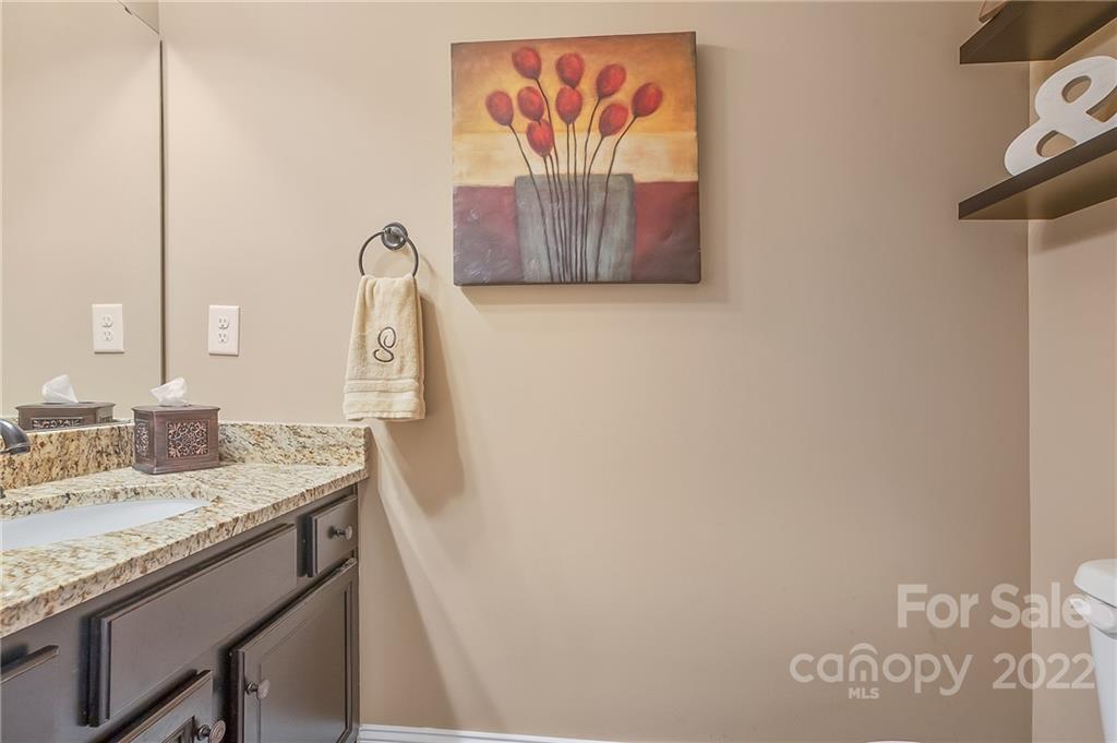 624 Spur Alley, Unit 19 Rutherfordton, NC 28139 - Photo 27 of 41 a bathroom with a granite countertop sink and a mirror