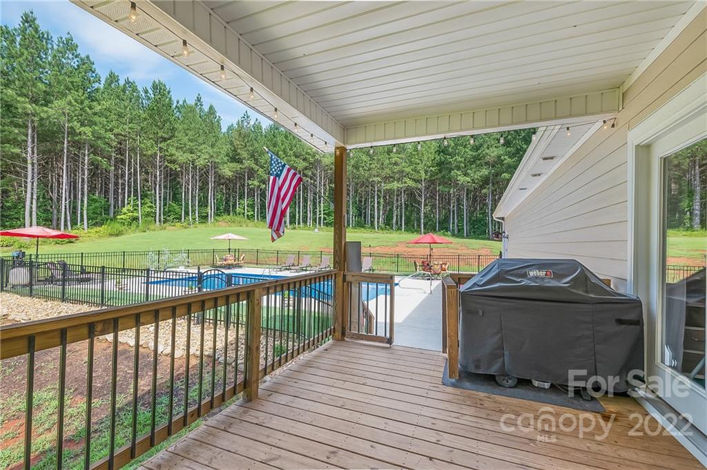 624 Spur Alley, Unit 19 Rutherfordton, NC 28139 - Photo 41 of 41 a view of a deck with a table chairs and a backyard