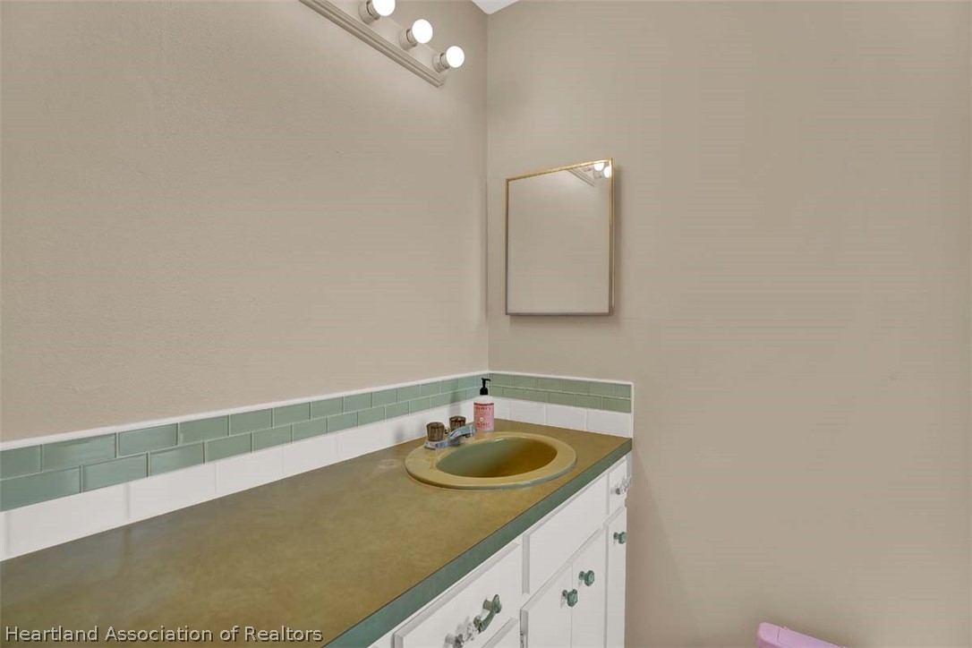 3232 Golfview Road Sebring, FL 33875 - Photo 11 of 36 a bathroom with a sink and a mirror