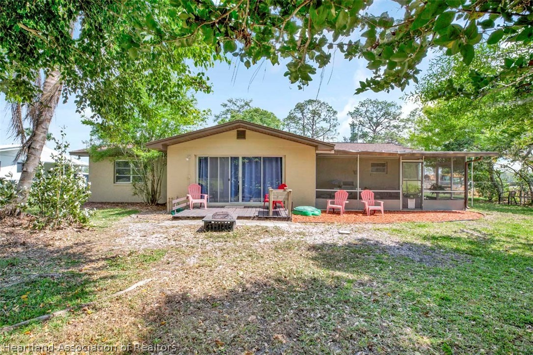 3232 Golfview Road Sebring, FL 33875 - Photo 22 of 36 a view of a house with backyard sitting area and garden