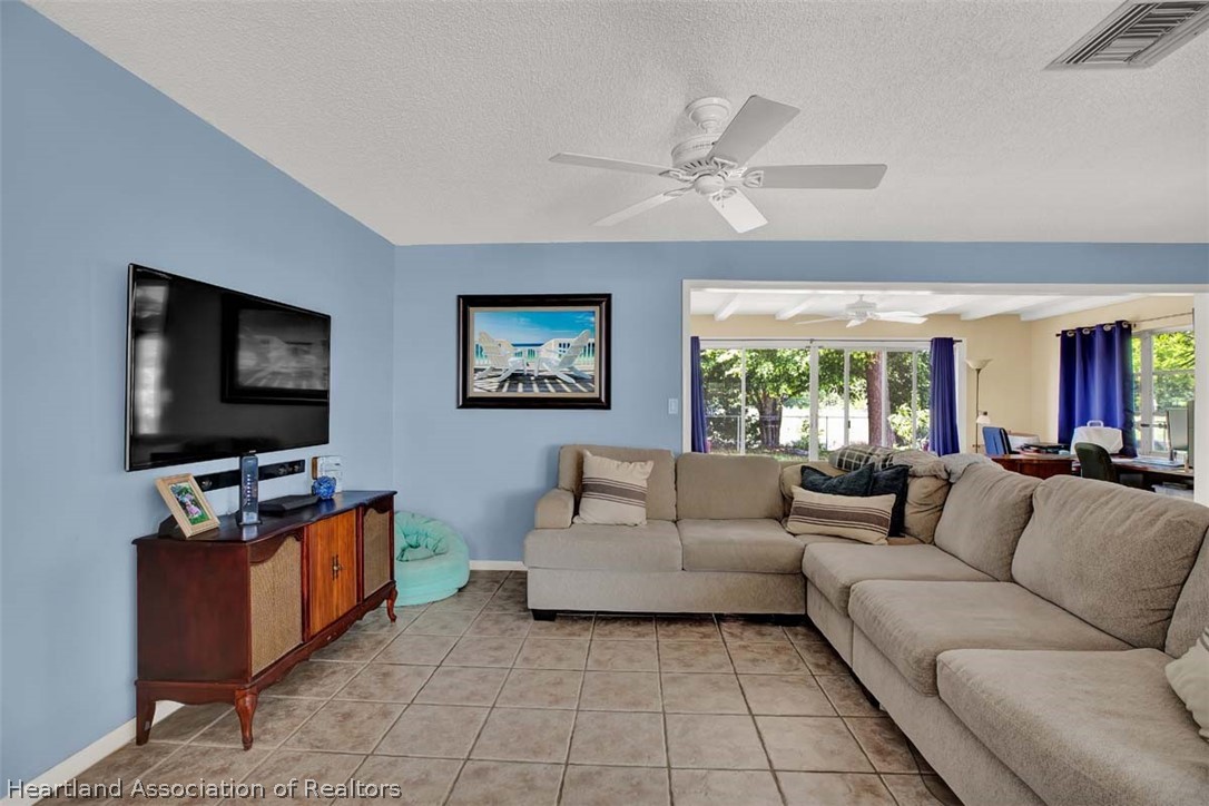 3232 Golfview Road Sebring, FL 33875 - Photo 3 of 36 a living room with furniture and a flat screen tv