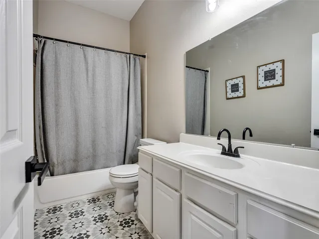 a bedroom with a bed lamp and a potted plant