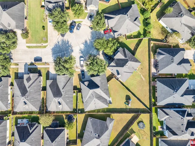 an aerial view of houses with outdoor space