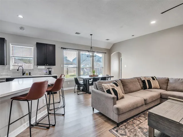 a living room with furniture a rug and a flat screen tv