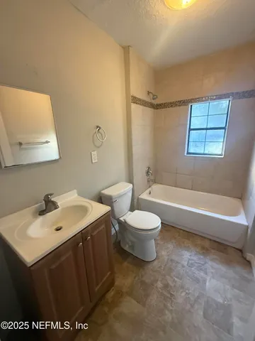 a bathroom with a sink a toilet and vanity