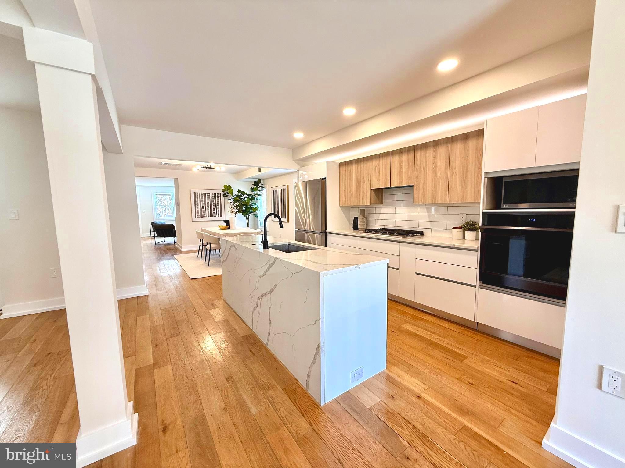 310 South Alfred Street Alexandria, VA 22314 - Photo 15 of 63 a living room with stainless steel appliances kitchen island granite countertop a stove a sink a refrigerator and cabinets