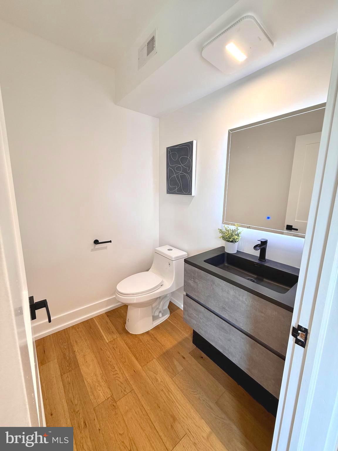 310 South Alfred Street Alexandria, VA 22314 - Photo 24 of 63 a bathroom with a sink toilet and mirror