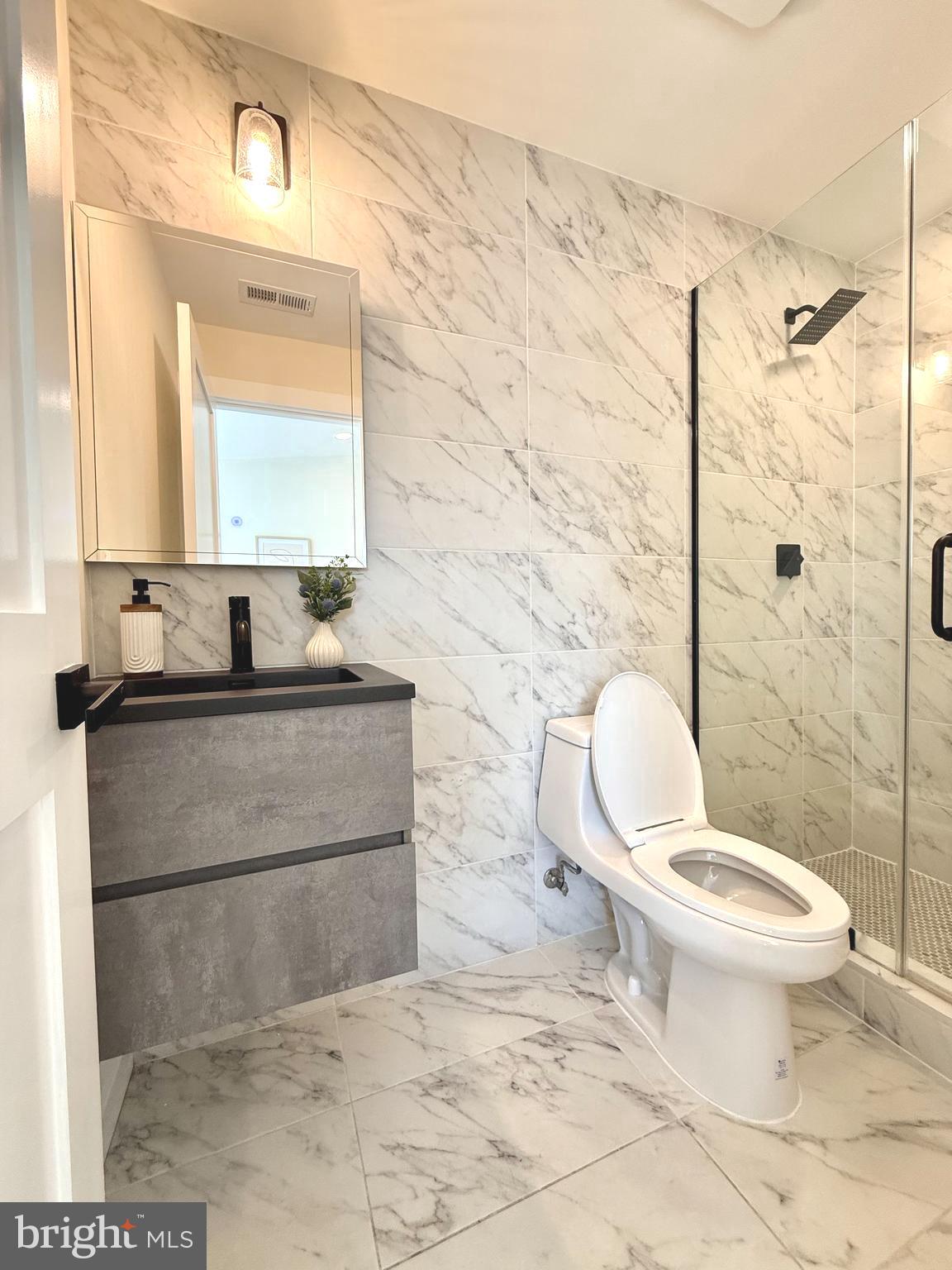 310 South Alfred Street Alexandria, VA 22314 - Photo 40 of 63 a bathroom with a toilet sink and mirror
