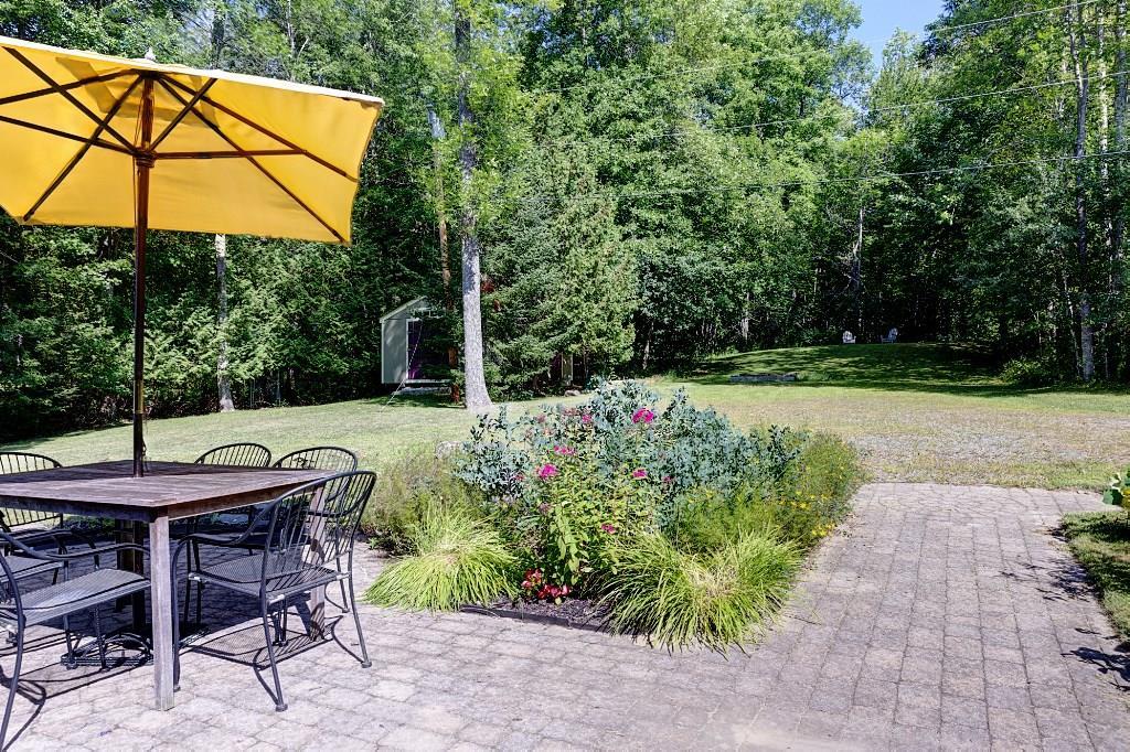 72 38th Fire Road South China, ME 04358 - Photo 7 of 18 Paved raised garden area has a grill...