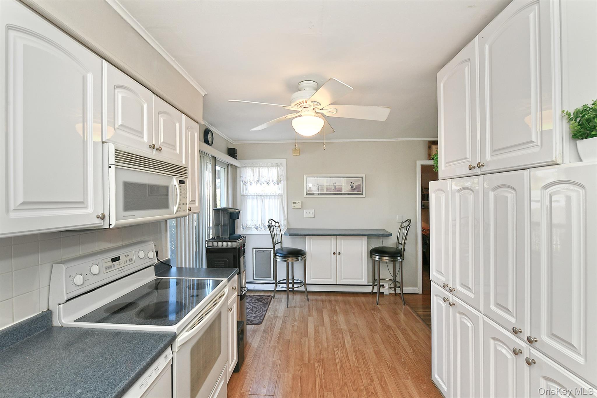 115 Old Farmingdale Road West Babylon, NY 11704 - Photo 13 of 30 a kitchen with stainless steel appliances granite countertop a stove and a refrigerator