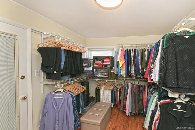 a view of walk in closet with clothes and shoes