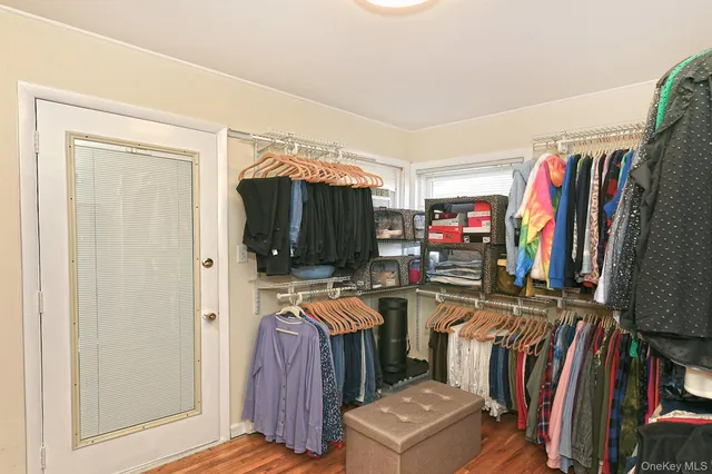 a view of walk in closet with clothes and shoes