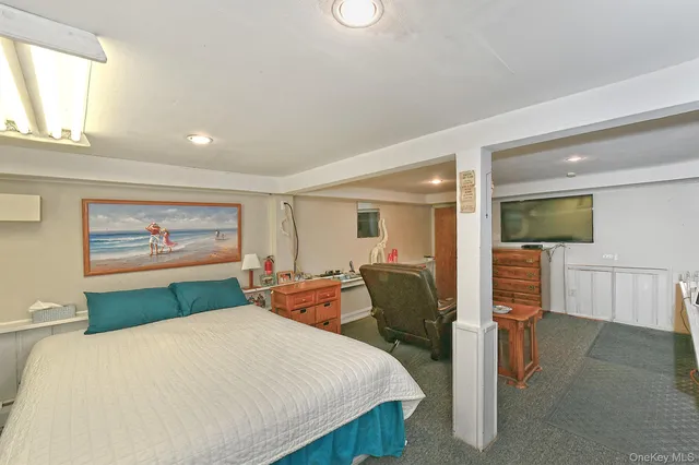 a bedroom with a large bed and a chandelier