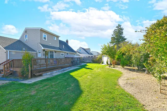 a view of yard with swimming pool and deck