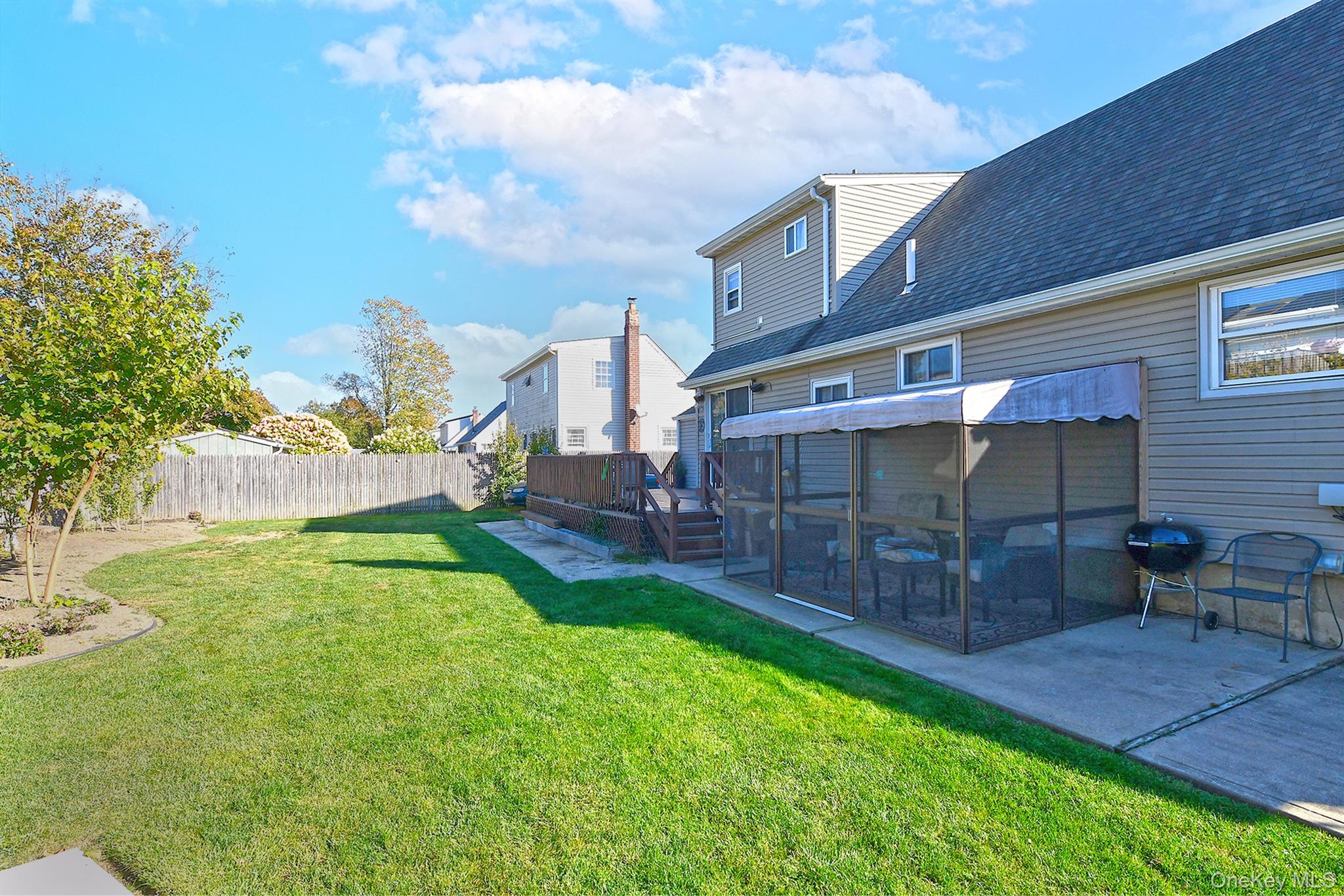 115 Old Farmingdale Road West Babylon, NY 11704 - Photo 29 of 30 a backyard of a house with table and chairs