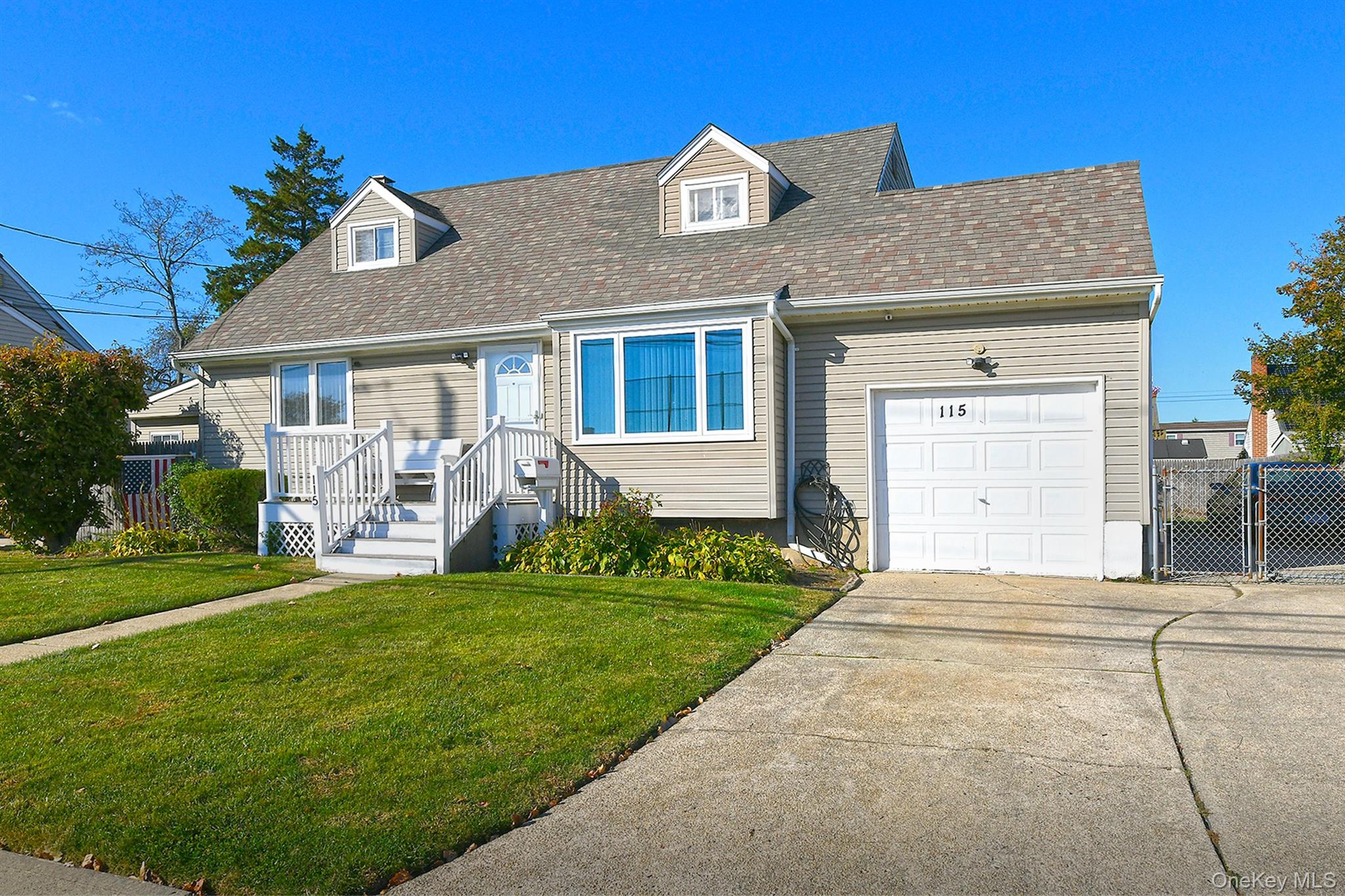 115 Old Farmingdale Road West Babylon, NY 11704 - Photo 3 of 30 a front view of a house with a garden and yard