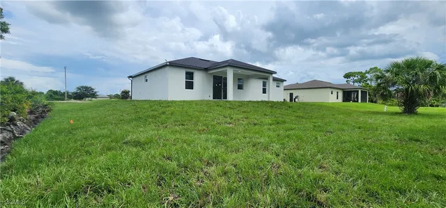 a front view of house with yard and green space