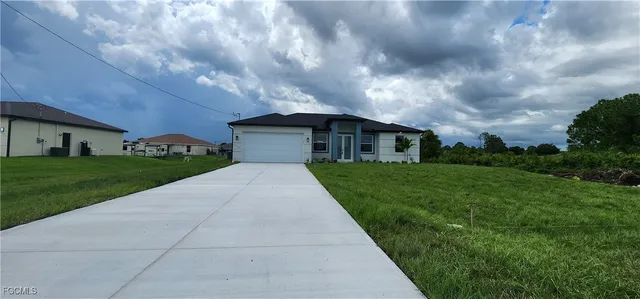 a front view of a house with a garden
