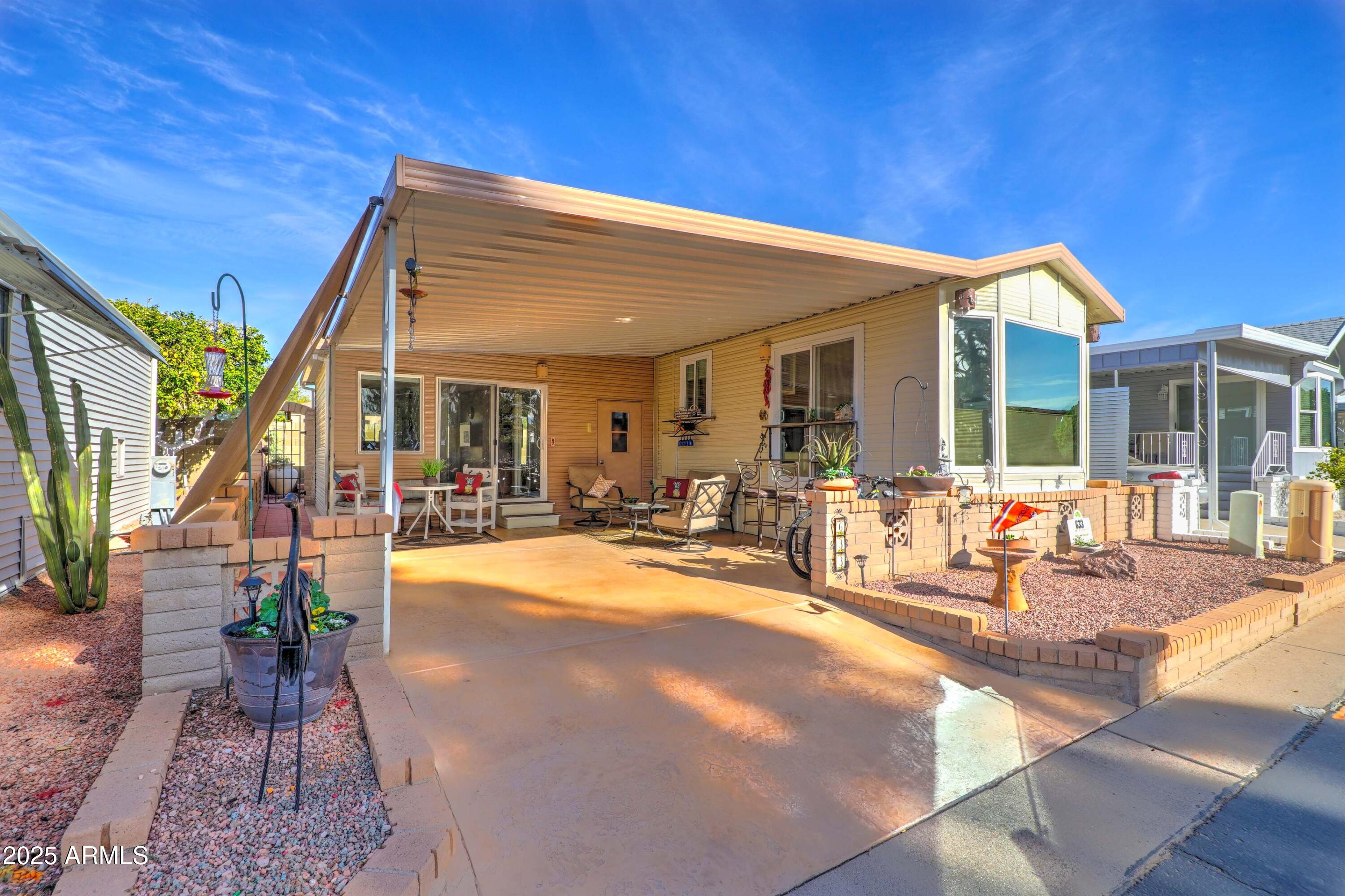111 South Greenfield Road, Unit 633 Mesa, AZ 85206 - Photo 2 of 32 a view of a house with outdoor seating